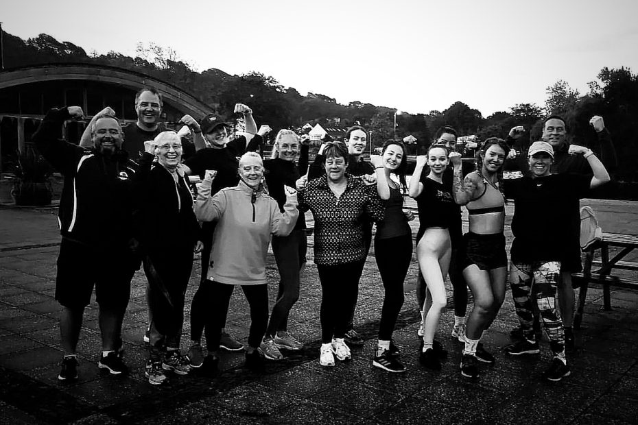Early morning bootcamp members showing team celebration and community vibe