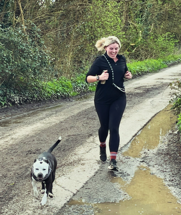Runner and her dog looking proud as they come to the finish